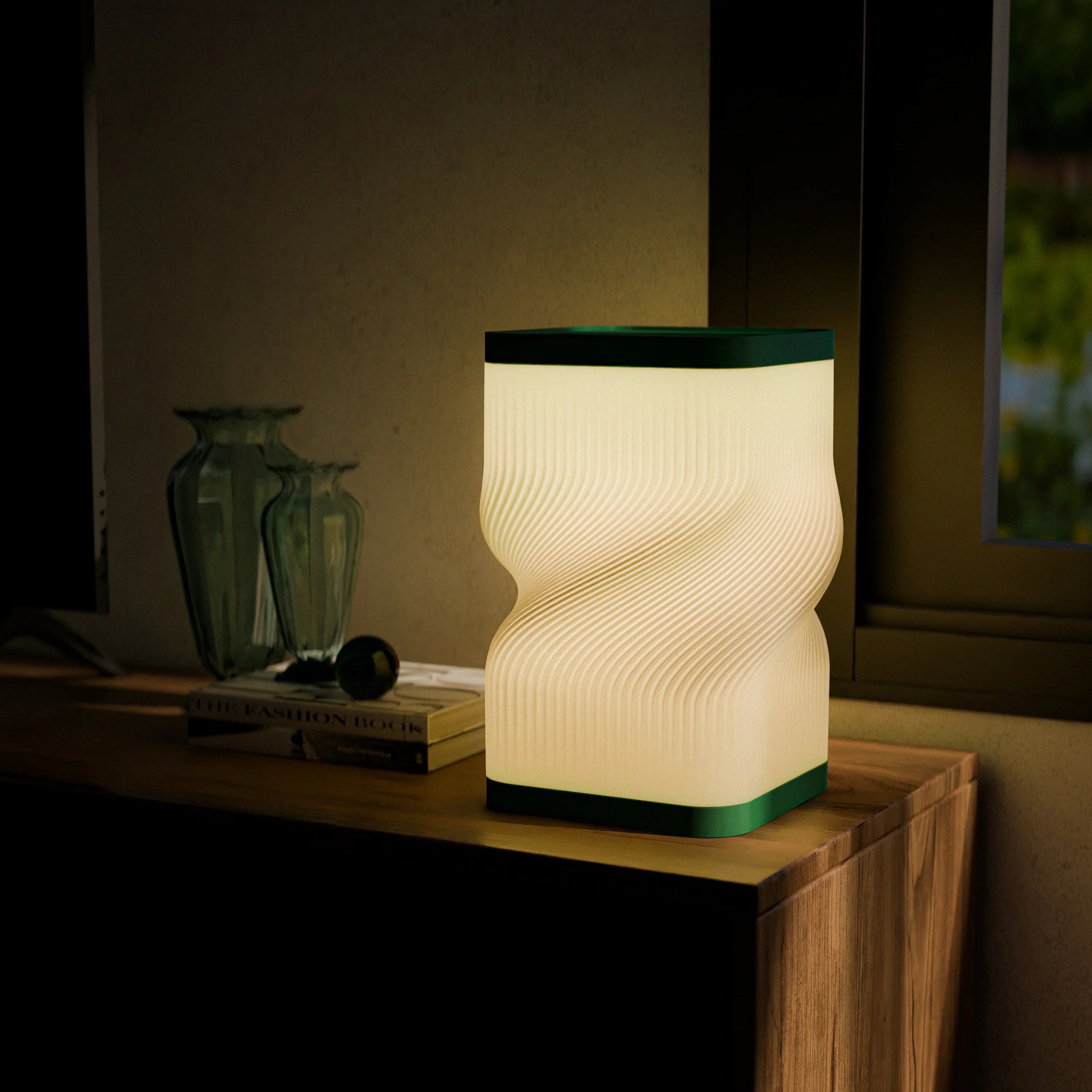 Wave-patterned lamp on a wooden surface with a warm glow